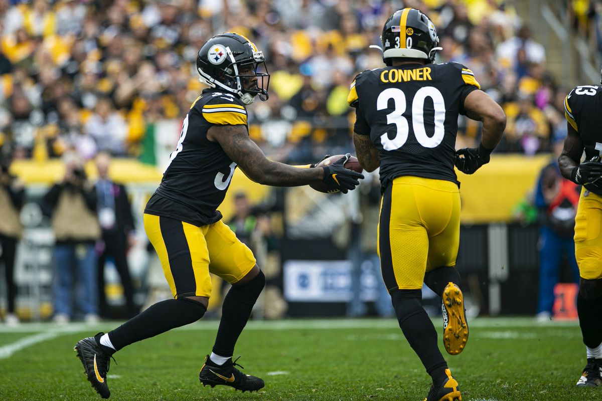 Pittsburgh Steelers running back Jaylen Samuels  fakes a handoff to Pittsburgh Steelers running back James Conner while in the wildcat formation during a game between the Baltimore Ravens and the Pittsburgh Steelers on October 06, 2019 at Heinz Field.