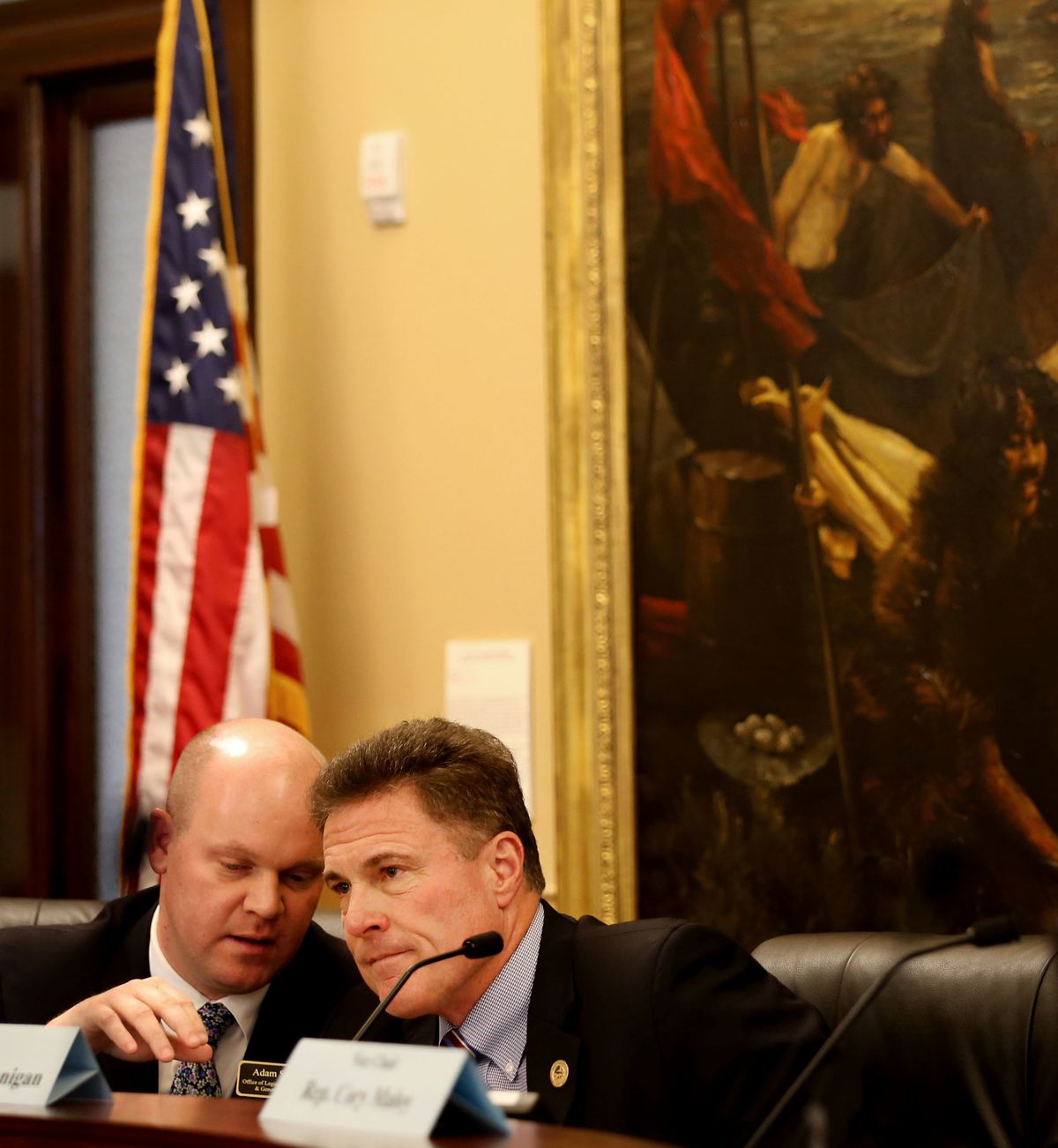 Policy analyst Adam J. Sweet, left, and Rep. Jim Dunnigan, R-Taylorsville, confer before the Medicaid Expansion Adjustments bill is discussed at the Capitol in Salt Lake City on Wednesday, Feb. 6, 2019.
