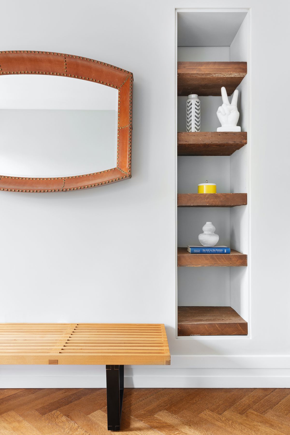 A wall with built-in wooden shelving. 