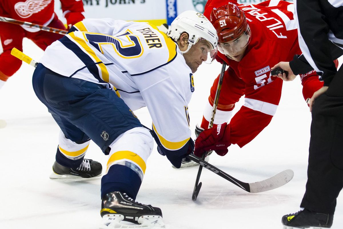 March 30, 2012; Detroit, MI, USA; Nashville Predators center Mike Fisher (12) and Detroit Red Wings center Valtteri Filppula (51) prepare to face-off in the second period at Joe Louis Arena. Mandatory Credit: Rick Osentoski-US PRESSWIRE