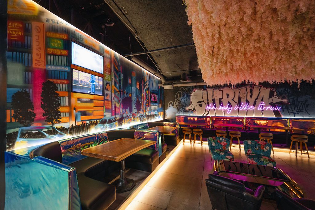 A colorful mural decorates a lounge and bar. 