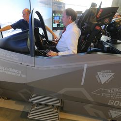 Utah Gov. Gary R. Herbert gets instructions from demonstrator pilot Eric Best as he takes a ride Wednesday, Oct. 7, 2015, in an F-35 cockpit demonstrator, at the University of Utah. Lockheed Martin and Hill Air Force Base, teamed up to bring the demonstrator to the Rio Tinto Kennecott Mechanical Engineering Building. 