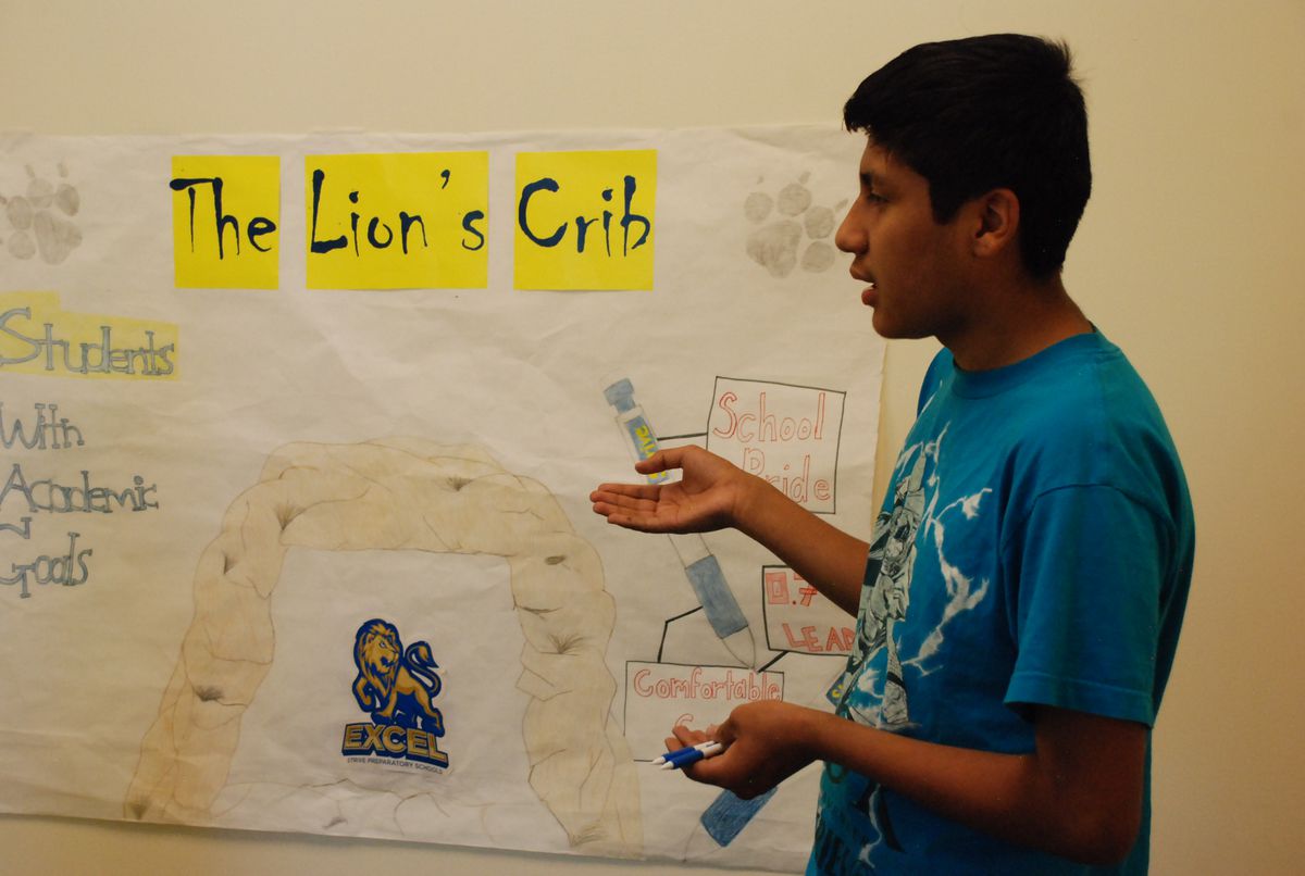 A student at STRIVE Excel rehearses a script for a student store run by the students at the high school.