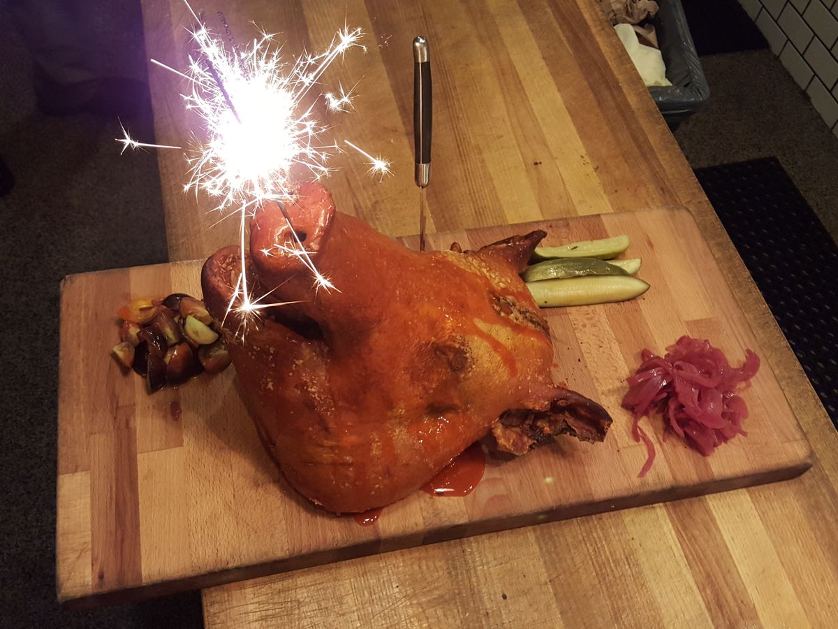 The whole roasted and fried pig head — with sparklers — at The Pig.
