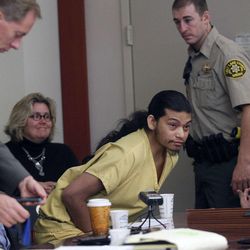 Esar Met, accused of killing 7-year-old Hser Ner Moo in 2008, sits at the defense table with lawyers  in Judge William Barrett's courtroom in Salt Lake City Tuesday Nov. 13, 2012,  for his preliminary hearing. 