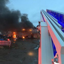 Firefighters attend to a fire that destroyed a vacant warehouse in Magna on Monday, March 28, 2016.