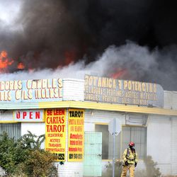 A store on Main Street and 1500 South burns in Salt Lake City on Wednesday, Nov. 18, 2015.  