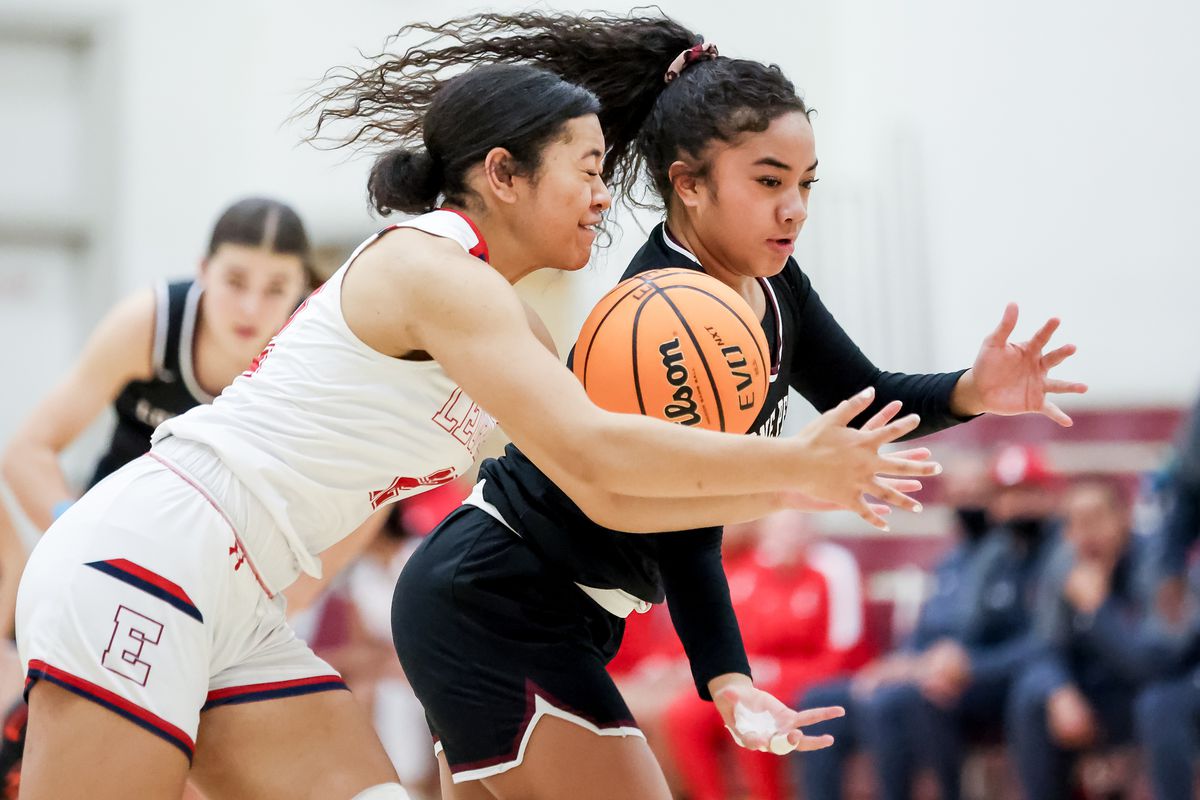 East’s Sila Tuakoi and Lone Peak’s Makeili Ika chase the ball in a girls basketball game at East High School in Salt Lake City on Tuesday, Dec. 7, 2021.