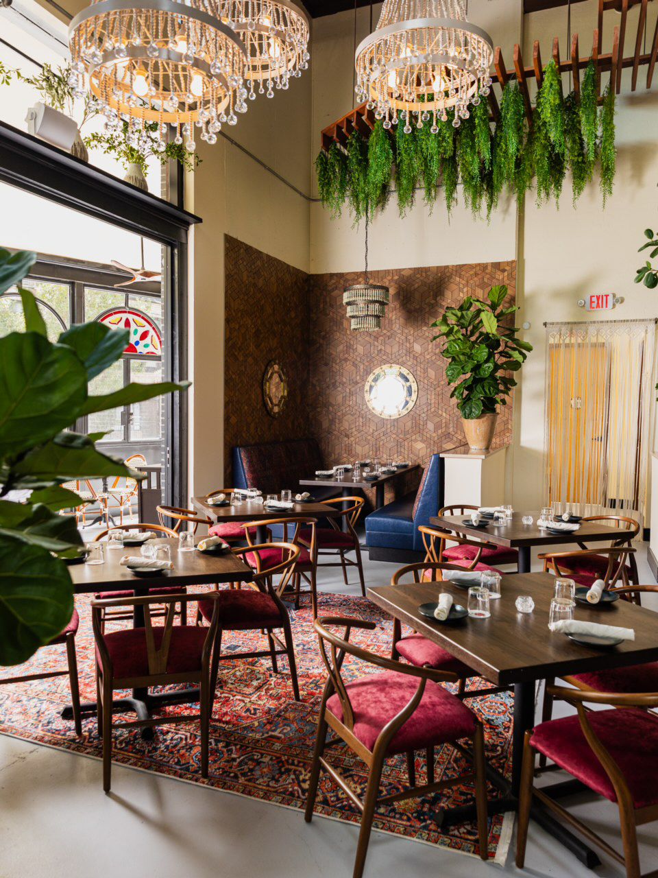 The colorful dining room at Persian restaurant Yalda in Atlanta with lush plants. 