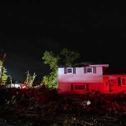 A home with a damaged roof sits on Everglade Ave and Woodridge Drive, after a tornado touched down near suburban Woodridge, Monday, June 21, 2021.