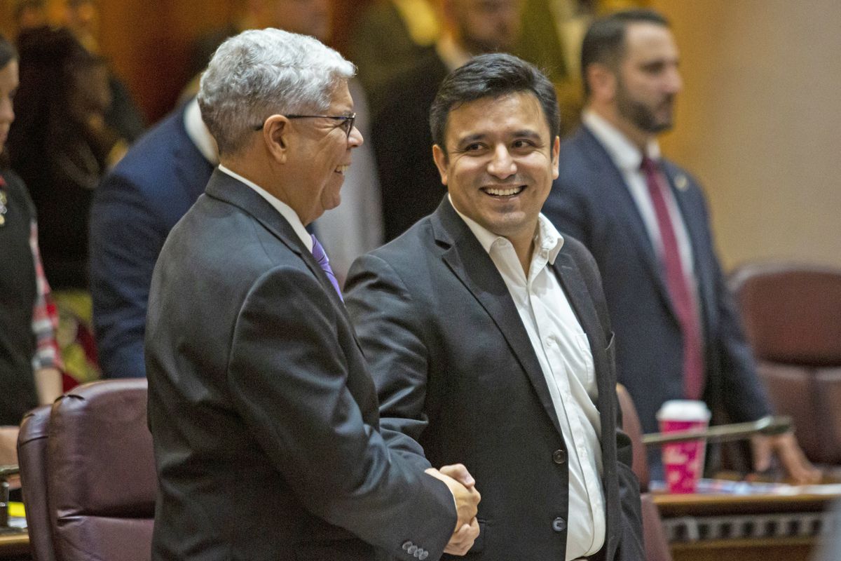 Ald. Byron Sigcho-Lopez (25th), center, shakes hands with Ald. Roberto Maldonado (26th) before a City Council meeting in 2019.