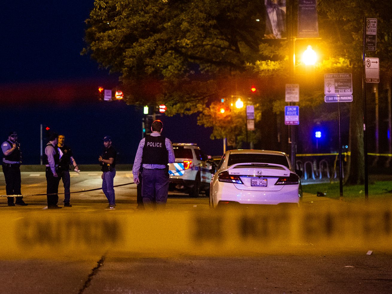 Chicago police investigate the scene where four people were shot, Saturday morning, in the 300 block of East Chicago, in the Gold Coast neighborhood. | Tyler LaRiviere/Sun-Times