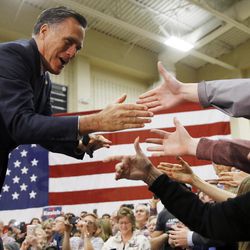 Former Republican presidential candidate Mitt Romney meets with attendees at a Republican presidential candidate, Ohio Gov. John Kasich campaign stop on Monday, March 14, 2016, at Westerville Central High School in Westerville, Ohio. 