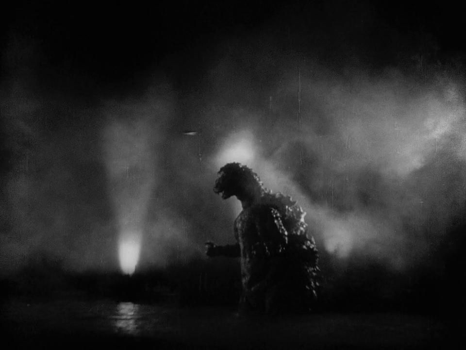 Godzilla walking through water in a still from the original Godzilla movie