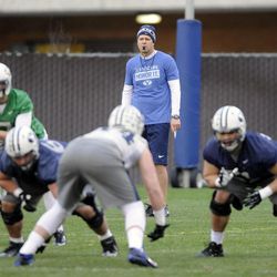 BYU coach Bronco Mendenhall watches as Christian Stewart runs the offense during a spring practice at BYU on Wednesday, March 5, 2014.