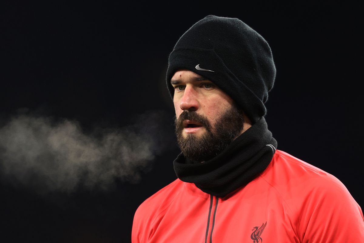 Liverpool goalkeeper Alisson Becker wrapped up against the cold during the Emirates FA Cup Third Round Replay match between Wolverhampton Wanderers and Liverpool at Molineux on January 17, 2023 in Wolverhampton, England.