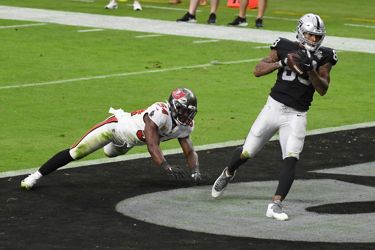 Tight end Darren Waller #83 of the Las Vegas Raiders catches a 1-yard touchdown pass in the end zone against inside linebacker Lavonte David #54 of the Tampa Bay Buccaneers during the second half of their game at Allegiant Stadium on October 25, 2020 in Las Vegas, Nevada.