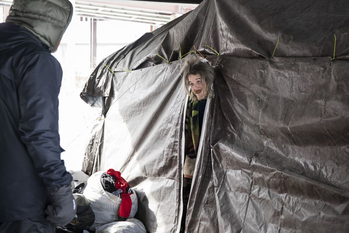 Members of The Night Ministry’s Street Medicine Outreach Team talk to Brian, who was living inside a tent in a homeless encampment on the Southwest Side, Tuesday, Jan. 29, 2019. The Street Medicine team provides people living in homeless encampments with 
