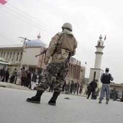Afghan security forces and and civilians walk around the Shiite Baqir-ul Ulom mosque after a suicide attack inside it, in Kabul, Afghanistan, Monday, Nov. 21, 2016. An Afghan official says that dozens of civilians have been killed after a suicide bomber attacked a Shiite mosque in the capital. 