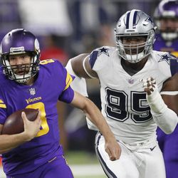 Minnesota Vikings quarterback Sam Bradford runs from Dallas Cowboys defensive tackle David Irving, right, during the second half of an NFL football game Thursday, Dec. 1, 2016, in Minneapolis. 