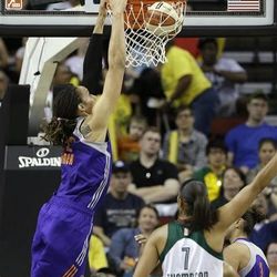Phoenix Mercury's Brittney Griner, left, attempts a dunk against the Seattle Storm late in the second half of a WNBA basketball game Sunday, June 2, 2013, in Seattle. Griner's shot was too late, just following a foul call. The Storm won 75-72.