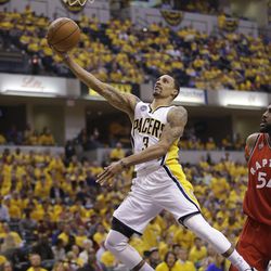 Indiana Pacers' George Hill goes to the basket against Toronto Raptors' Patrick Patterson during Game 6 of an NBA first-round playoff basketball series in Indianapolis.