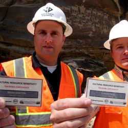 Jones & DeMille Engineering's Brian Barton, left, and Carbon County engineer Curtis Page display the cards that show they completed the cultural resource sensitivity training required for everyone working on the Nine Mile Canyon Road project, May 17, 2012. Archaeologists have worked closely with project managers to identify existing and newly discovered cultural sites in the canyon and document them during road construction.