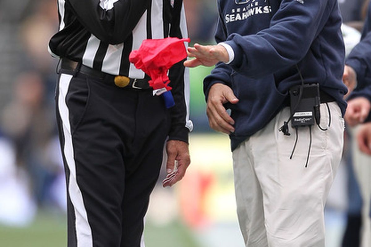 Pete Carroll distracts the ref with the old "levitating challenge flag" magic trick.