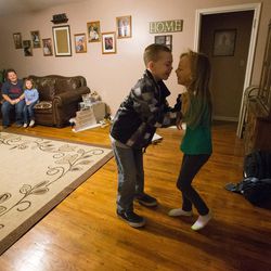 Britton Voss and sister Airiana play before he and his service dog Dopey go to school in Clearfield on Monday, Dec. 19, 2016.