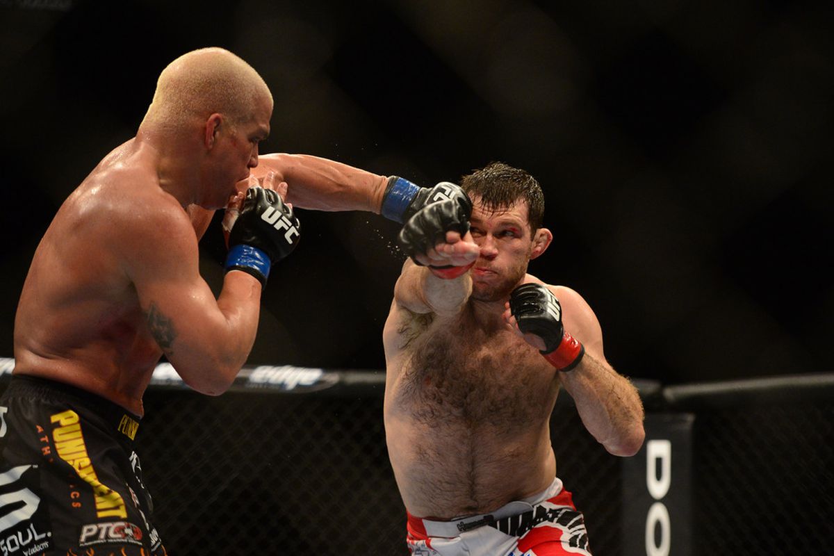 Jul. 7, 2012; Las Vegas, NV, USA; UFC fighter Tito Ortiz (left) punches Forrest Griffin during a light heavyweight bout in UFC 148 at the MGM Grand Garden Arena. Mandatory Credit: Mark J. Rebilas-US PRESSWIRE