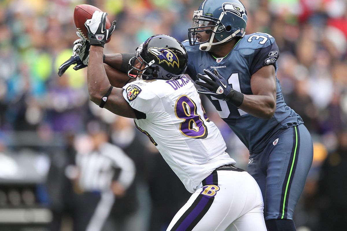 SEATTLE - NOVEMBER 13:  Safety Kam Chancellor #31 of the Seattle Seahawks breaks up a pass to Ed Dickson #84 of the Baltimore Ravens at CenturyLink Field on November 13, 2011 in Seattle, Washington. (Photo by Otto Greule Jr/Getty Images)