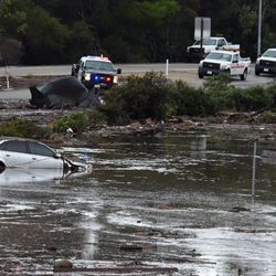 This photo provided by the Santa Barbara County Fire Department shows the U.S. Highway 101 at the Olive Mill Road overpass flooded with runoff water from Montecito Creek in Montecito, Calif., Tuesday, Jan. 9, 2018. Dozens of homes were swept away or heavily damaged Tuesday as downpours sent mud and boulders roaring down hills stripped of vegetation by a gigantic wildfire that raged in Southern California last month. (Mike Eliason/Santa Barbara County Fire Department via AP)