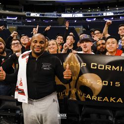 Daniel Cormier poses with fans at UFC 230 workouts.