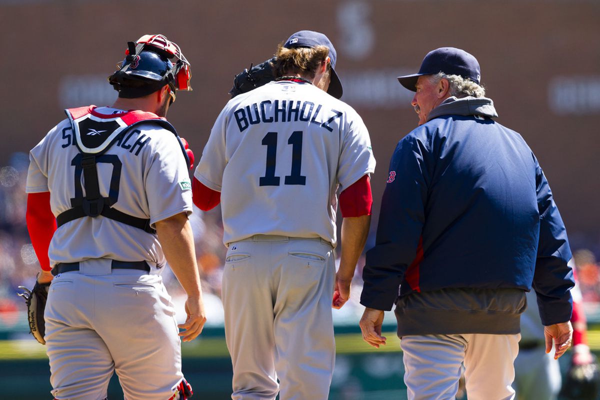 Detroit, MI, USA; Boston Red Sox pitching coach Bob McClure (right) talks to starting pitcher Clay Buchholz (11) and catcher Kelly Shoppach (10) against the Detroit Tigers at Comerica Park. Mandatory Credit: Rick Osentoski-US PRESSWIRE