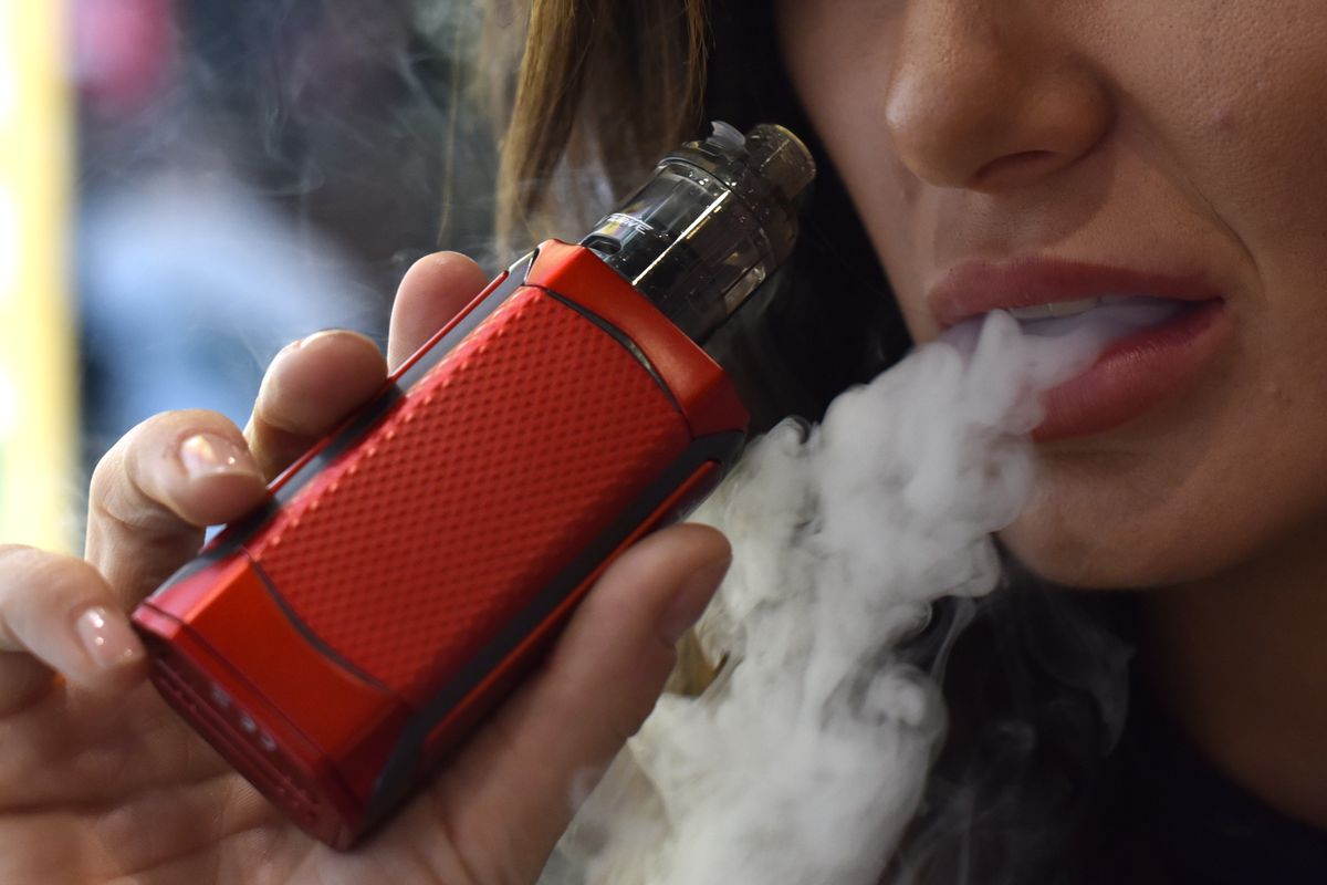 a picture of a woman vaping