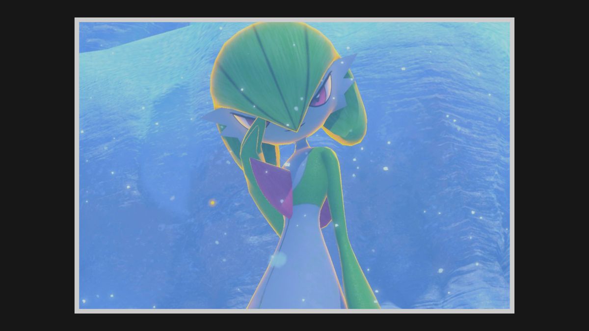 A Gardevoir smiles and poses in the snow