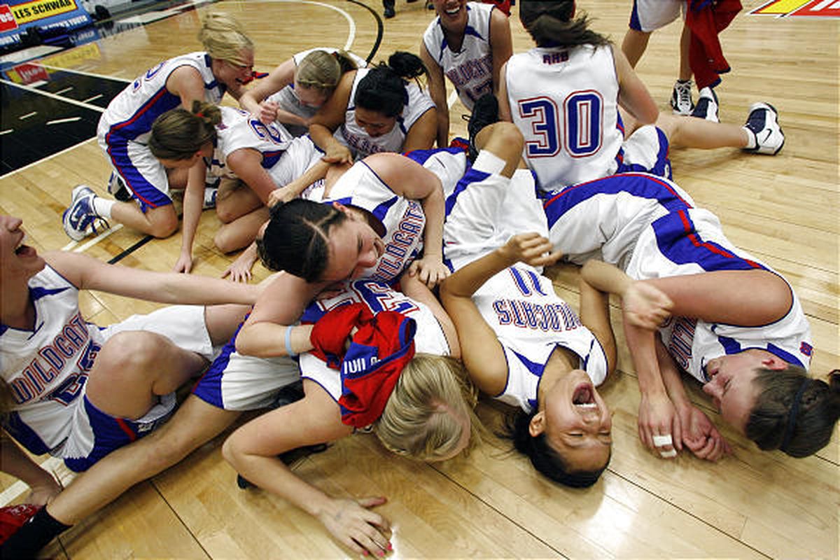 Richfield players mob each other as they celebrate winning the 3A girls basketball state championship over Union.
