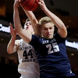 Brigham Young Cougars guard Connor Harding (44) battles for a rebound with San Diego Toreros forward Yauhen Massalski (25) as the BYU Cougars and San Diego Toreros play in WCC tournament action at the Orleans Arena in Las Vegas on Saturday, March 9, 2019. San Diego won 80-57.