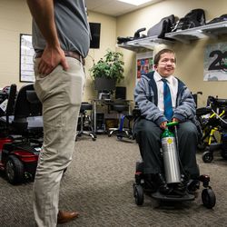 Rhett Carbine, 19, pilots his brand new wheelchair at Alpine Home Medical Equipment in Salt Lake City on Friday, Nov. 30, 2018. Carbine's personalized wheelchair that carried his oxygen tanks was stolen two weeks ago, and Alpine Home Medical Equipment provided him with a new one.