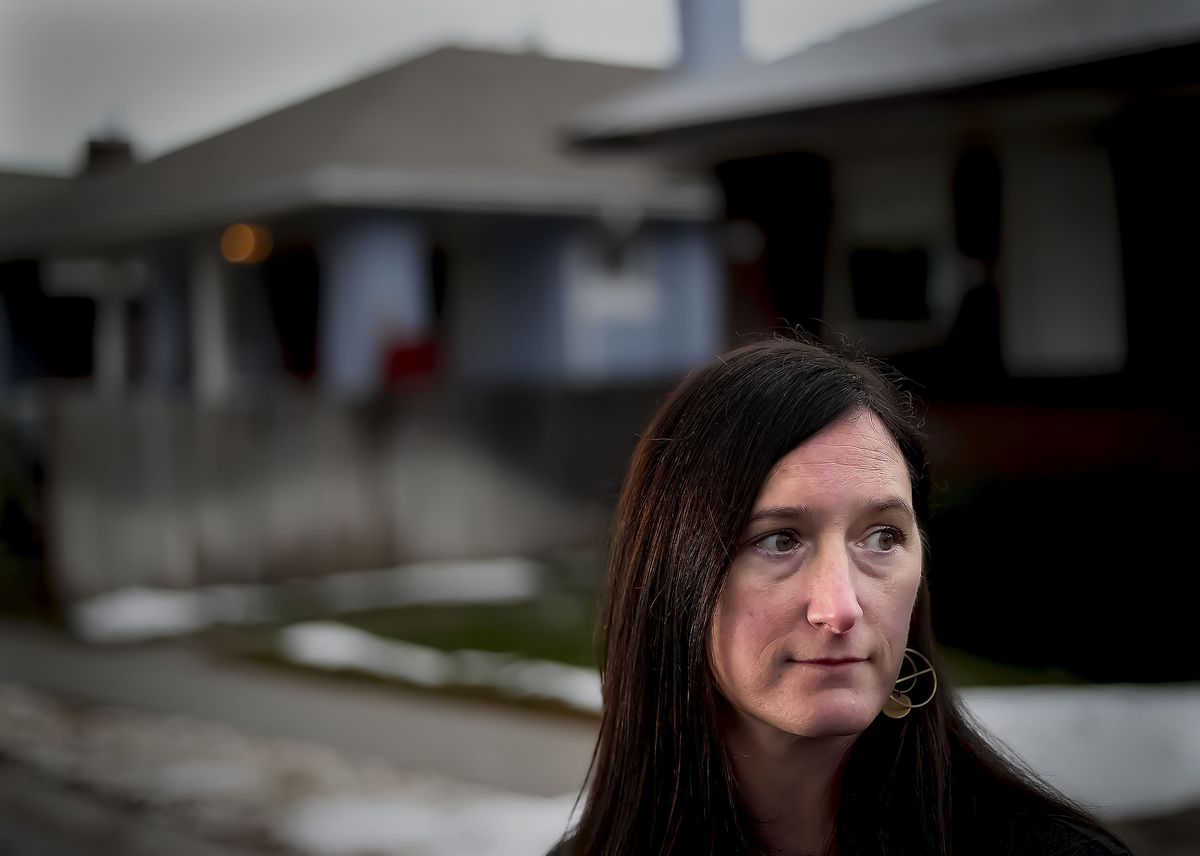 Monique Higginson stands on the street she grew up on in Salt Lake City on Thursday, Jan. 6, 2022. It’s been 30 years since Higginson left a home life that was a chaos of anxiety, violence and poverty under the dark shadows of her parents’ addictions.