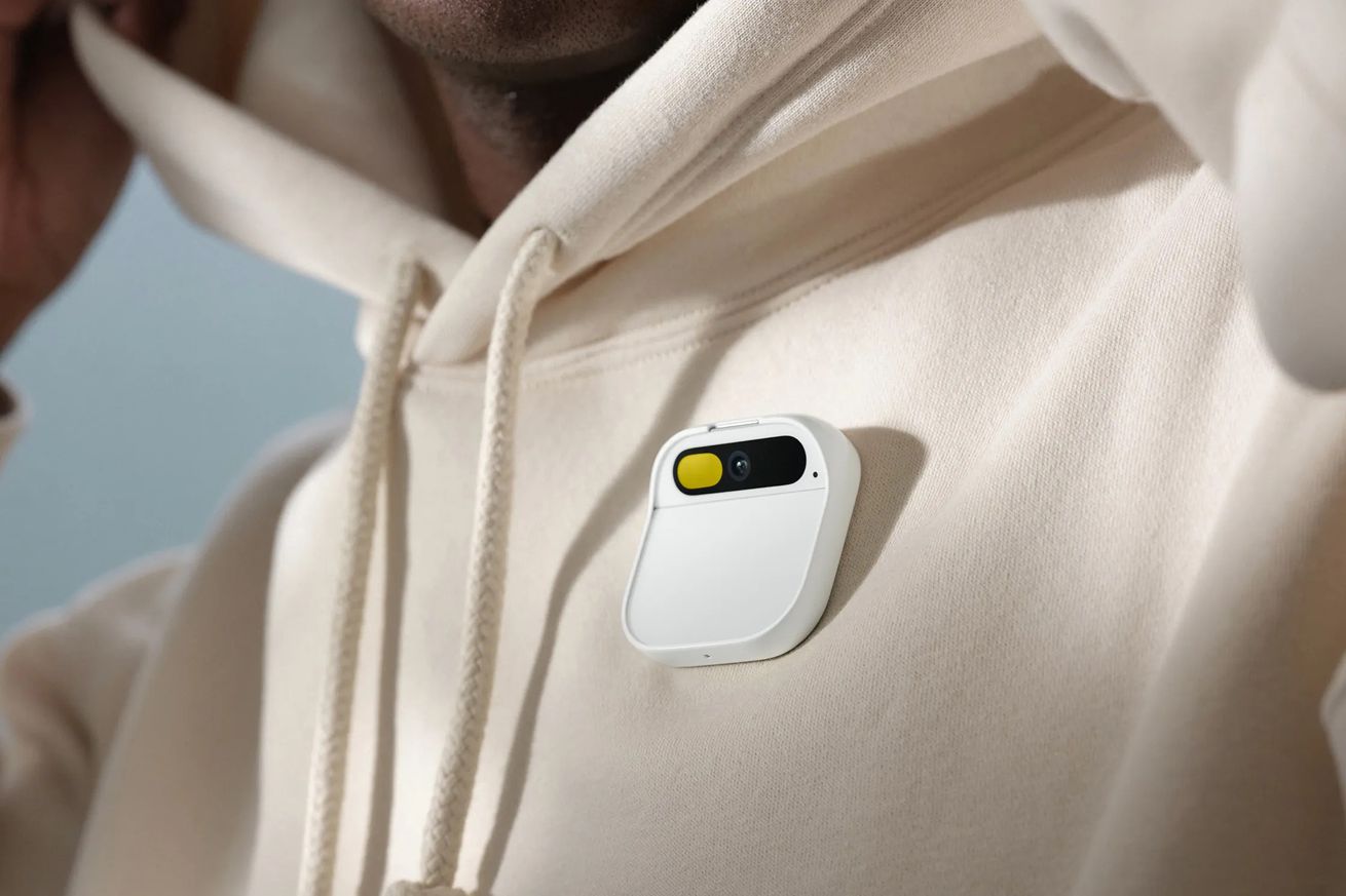 An image of the Humane AI Pin on a light colored sweatshirt