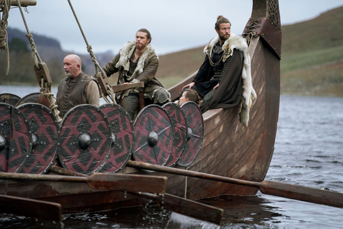 Leif, Liv, and Harald sit on a boat looking toward the distance in Vikings: Valhalla