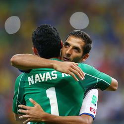 oalkeeper Keylor Navas of Costa Rica (L) hugs teammate Celso Borges.