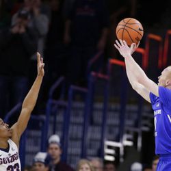 BYU guard TJ Haws, right, shoots over Gonzaga guard Zach Norvell Jr. during the second half of an NCAA college basketball game in Spokane, Wash., Saturday, Feb. 3, 2018. Gonzaga won 68-60. (AP Photo/Young Kwak)