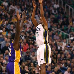 The Utah Jazz's Rodney Hood shoots from the 3-point line against LA Laker Brandon Bass at the Vivint Smart Home Arena in Salt Lake City on Monday, March 28,  2016.  