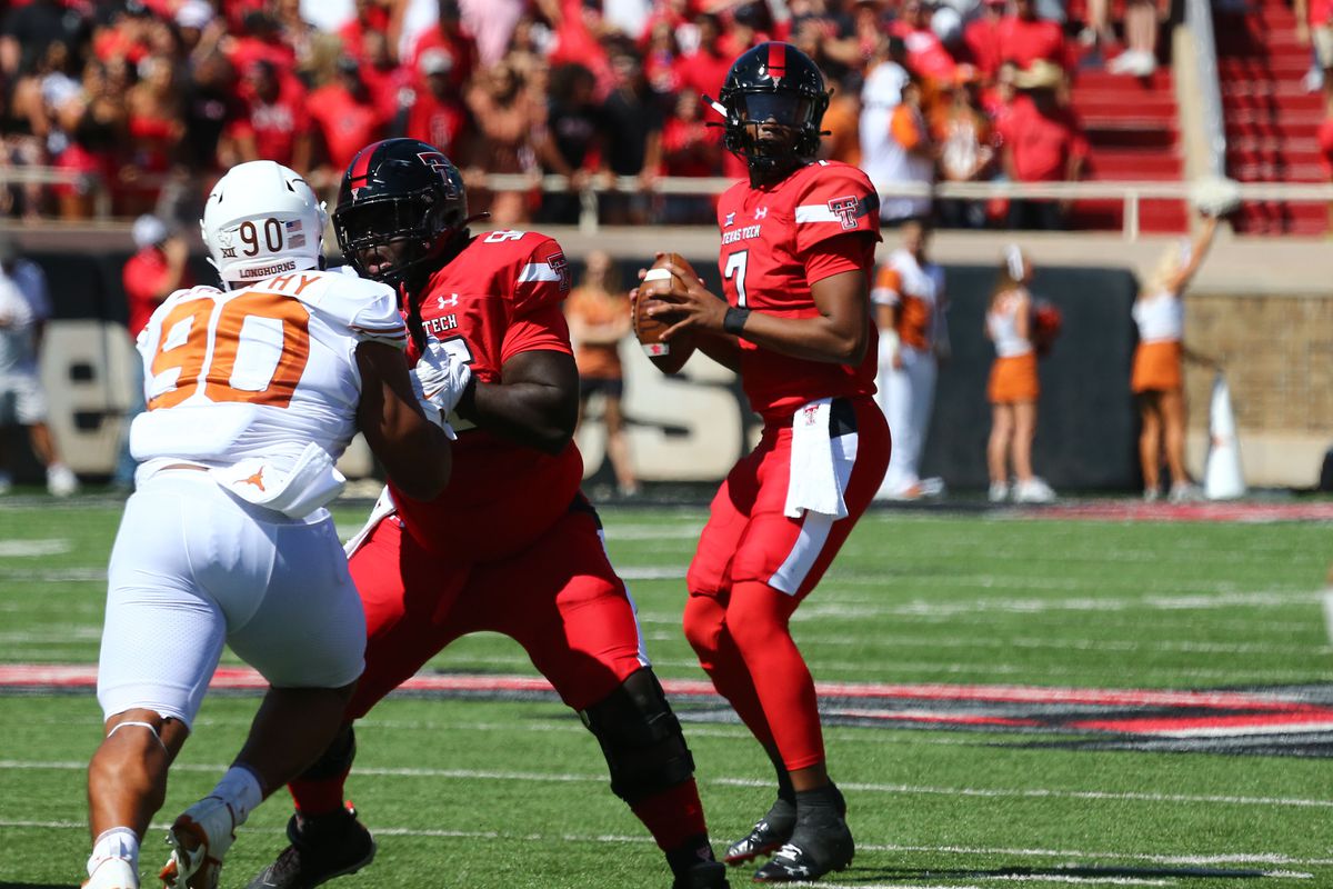Texas Tech Red Raiders quarterback Donovan Smith passes against the Texas Longhorns as center Dennis Wilburn blocks defensive tackle Byron Murphy in the first half at Jones AT&amp;T Stadium and Cody Campbell Field.&nbsp;