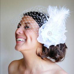 <b>2. Flower Fascinator with Veil, <a href=https://www.etsy.com/listing/99247480/white-bridal-hair-fascinator-merry-widow?ref=shop_home_active_18">$87.50</a></b> at Etsy. For the true girly-girl, this flirty hair fascinator makes a statement and can be wo