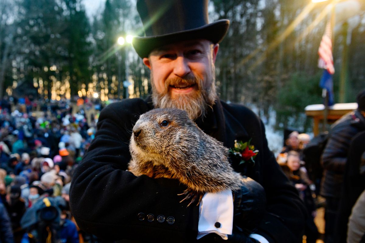 Groundhog handler AJ Derume holds Punxsutawney Phil, who saw his shadow, predicting a late spring during the 136th annual Groundhog Day festivities on February 2, 2022 in Punxsutawney, Pennsylvania. Groundhog Day is a popular tradition in the United States and Canada. A crowd of upwards of 5000 people spent a night of revelry awaiting the sunrise and the groundhog’s exit from his winter den.