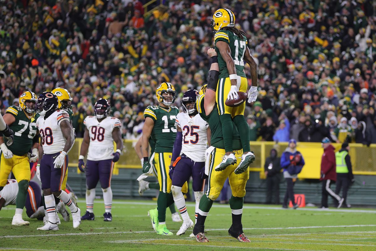 Davante Adams #17 of the Green Bay Packers is lifted by Abdullah Anderson #72 after a three-yard touchdown reception against the Chicago Bears during the fourth quarter of the NFL game at Lambeau Field on December 12, 2021 in Green Bay, Wisconsin.