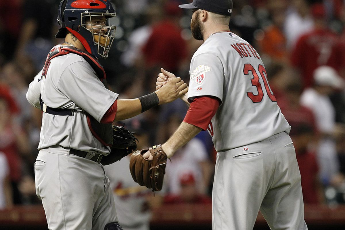 HOUSTON,TX-JUNE 06: Jason Motte #30 of the St. Louis Cardinals shakes hands with catcher Yadier Molina #2 after the final out as St. Louis defeated Houston 4-3 on June 6, 2012 at Minute Maid Park in Houston, Texas.  (Photo by Bob Levey/Getty Images)